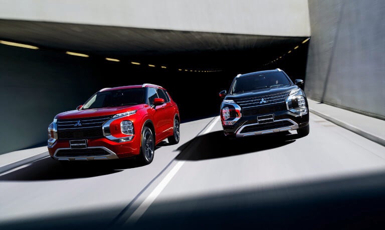 Two 2024 Mitsubishi Outlanders driving out of tunnel