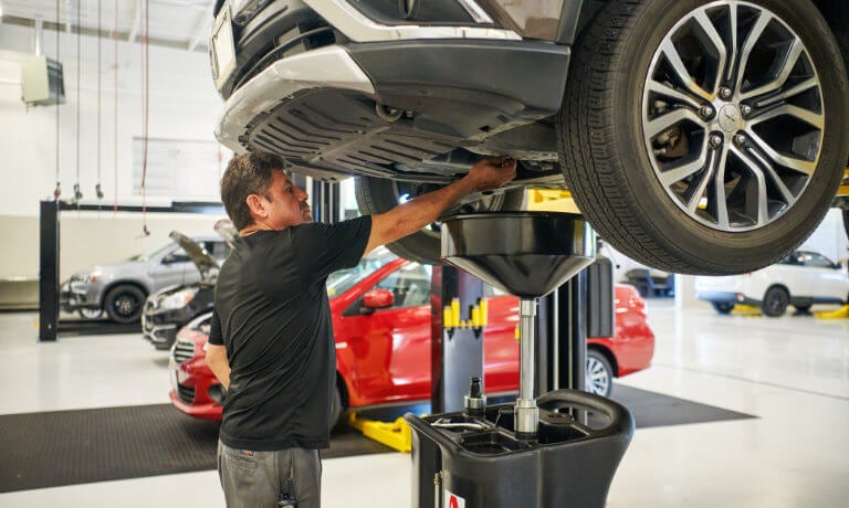 Mitsubishi technician changing oil